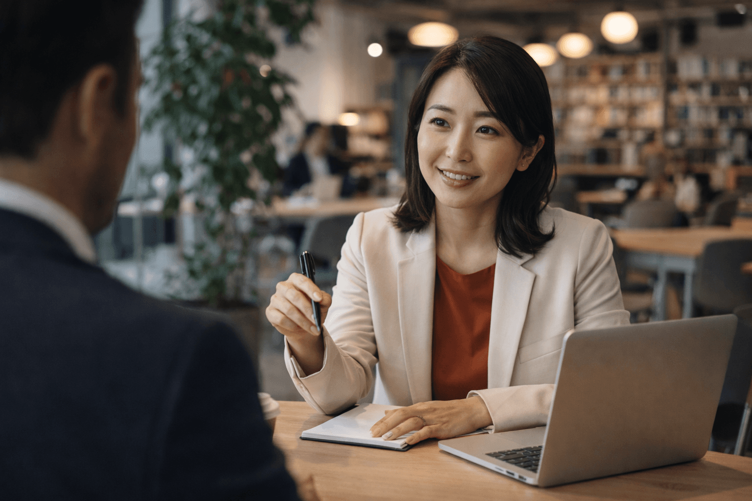 Two professionals discussing strategy at a wooden table