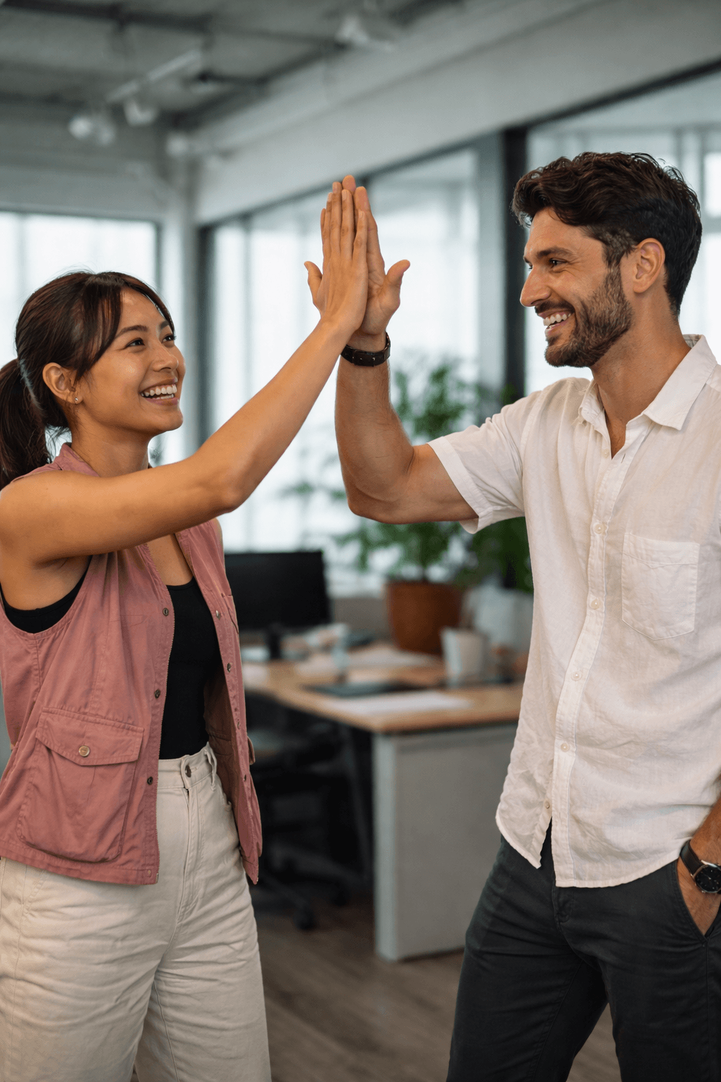 Colleagues high-fiving after a successful project milestone