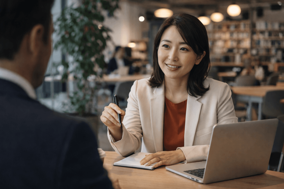 A consultant in conversation with a client across a table